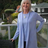 Woman wearing Silkspun Longline Cardigan over a Short Sleeved Crew top in Forget-Me-Not blue
