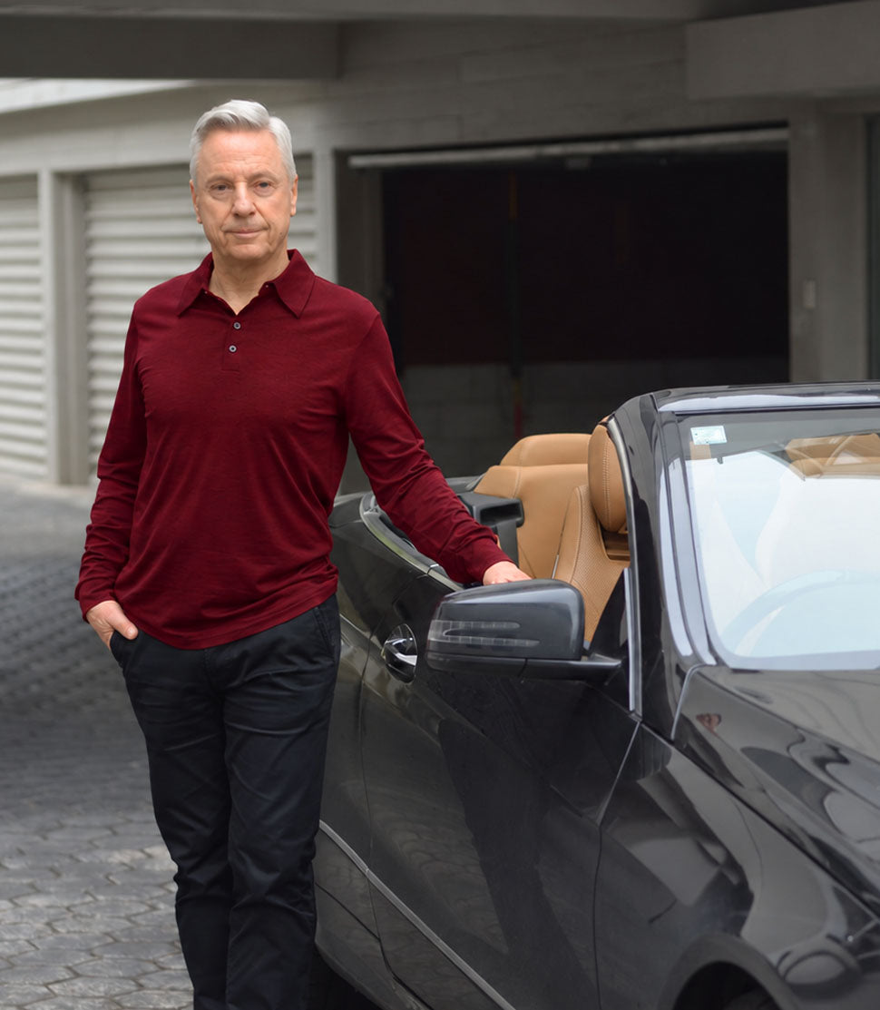 Man wearing a Silkspun Long Sleeved Polo Shirt in Bordeaux Red