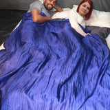 Two people sharing a 100% silk double sleeping bag liner in a tent.